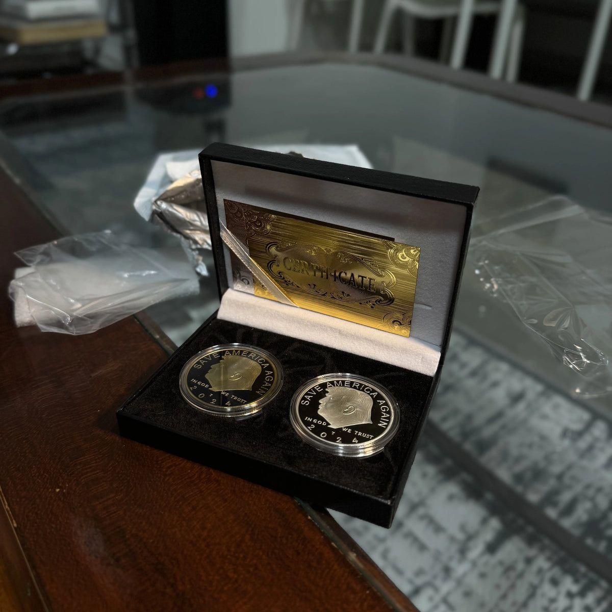 Trump gold and silver coin case on a desk with the lid open