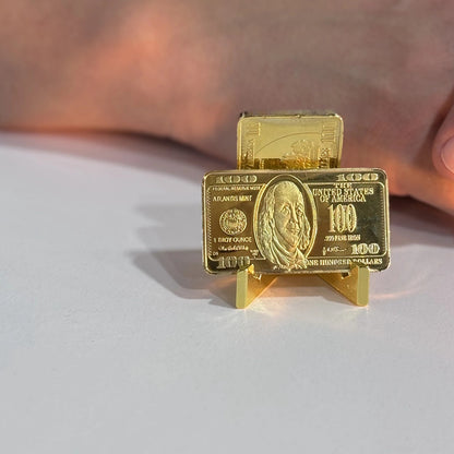 Ben Franklin $100 gold-plated bar front view standing on a small display stand