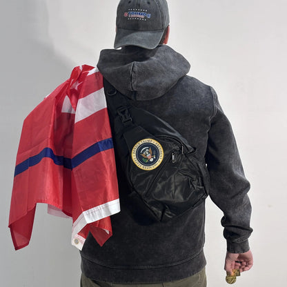 Man carrying the Trump 2024 Save America Again Flag over his shoulder