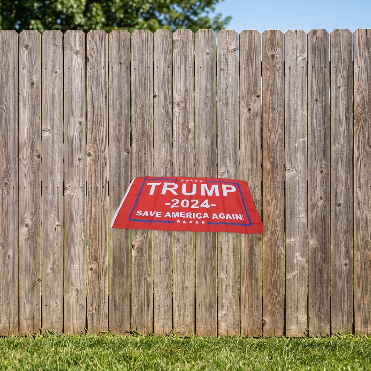 Trump 2024 Save America Again Flag hung on a backyard wooden fence