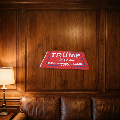 Trump 2024 Save America Again Flag hung on a wood-paneled den wall