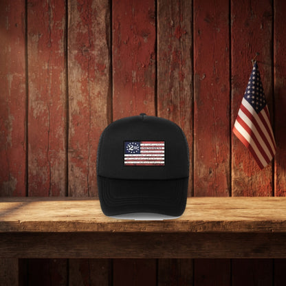 2nd Amendment Hat on a rustic barn shelf with a small flag