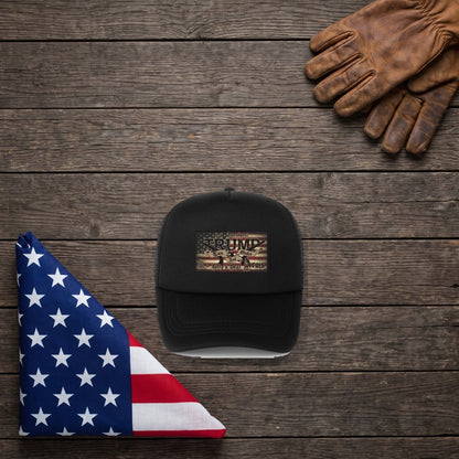 2nd Amendment Trump Hat on a dark wood table beside a folded American flag