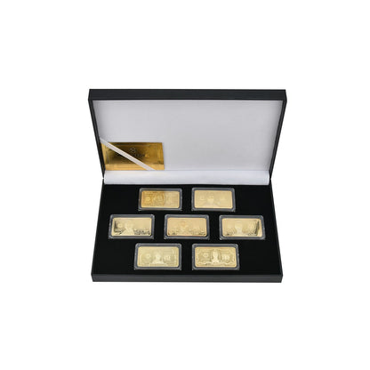 7-piece gold-plated currency bar set in its open black presentation box, studio shot