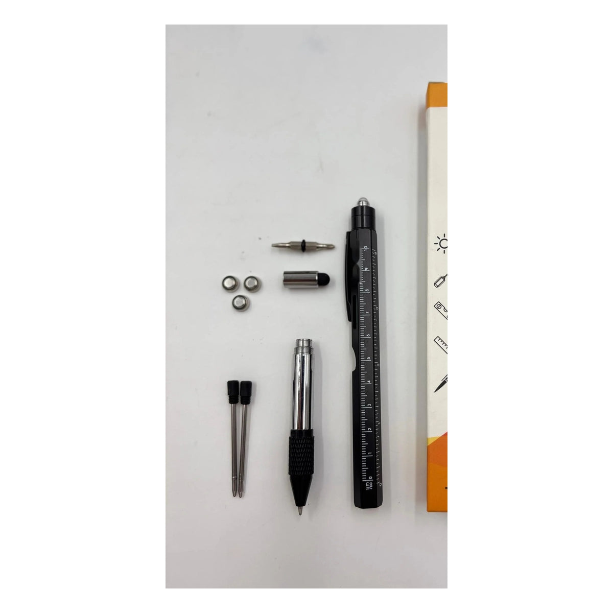 9-in-1 Multi-Tool Pen with its bits, stylus tip, spare refills and batteries laid out
