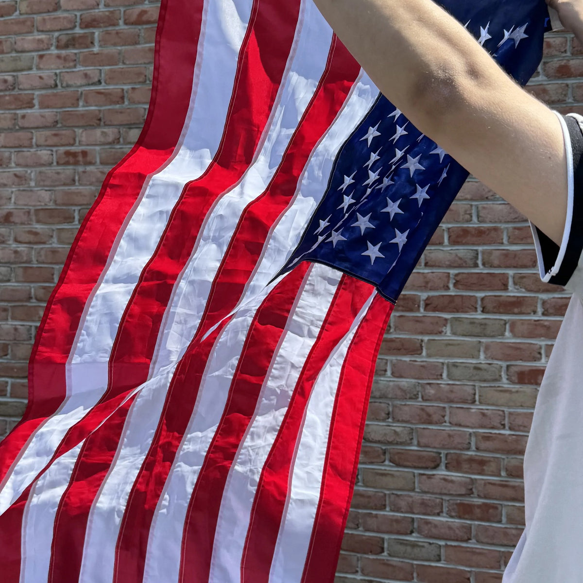 American Flag 3x5 ft held against a brick wall