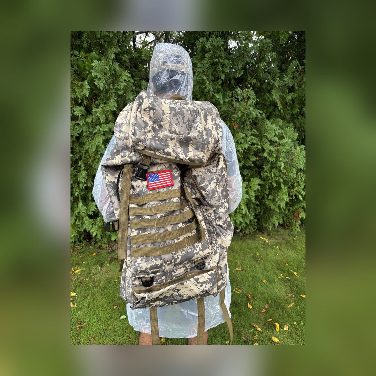 Person wearing the included poncho over the Bugout Backpack outdoors
