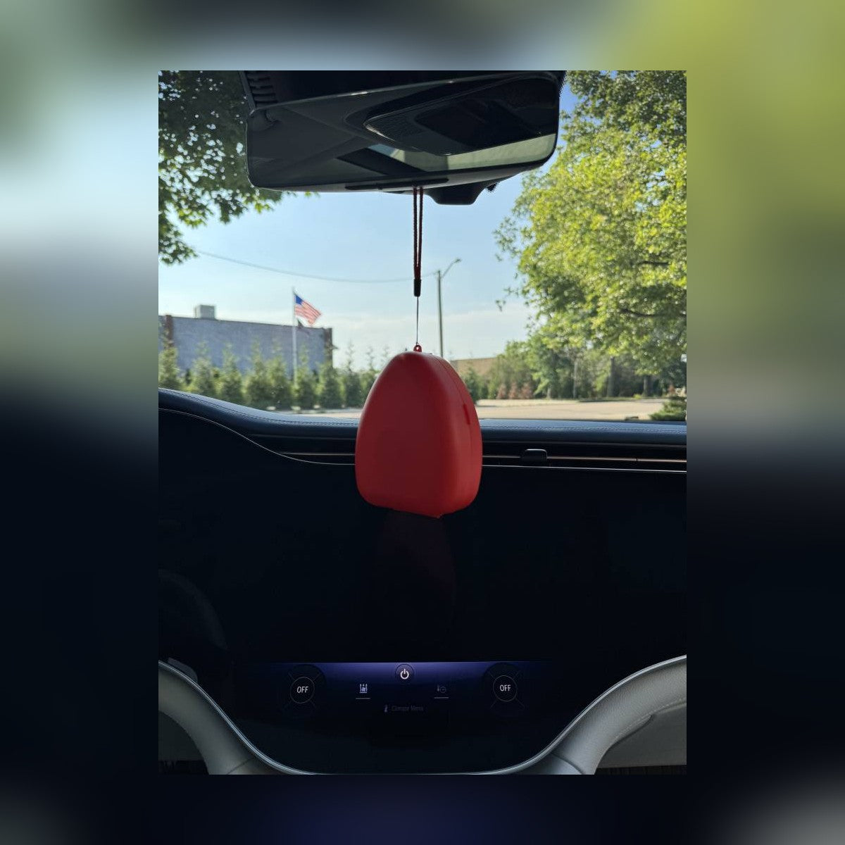 CPR Car Kit red case hanging by its lanyard inside a vehicle