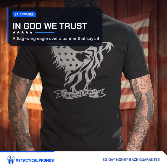 Eagle In God We Trust T-Shirt worn by a man in front of a red barn wall with an American flag