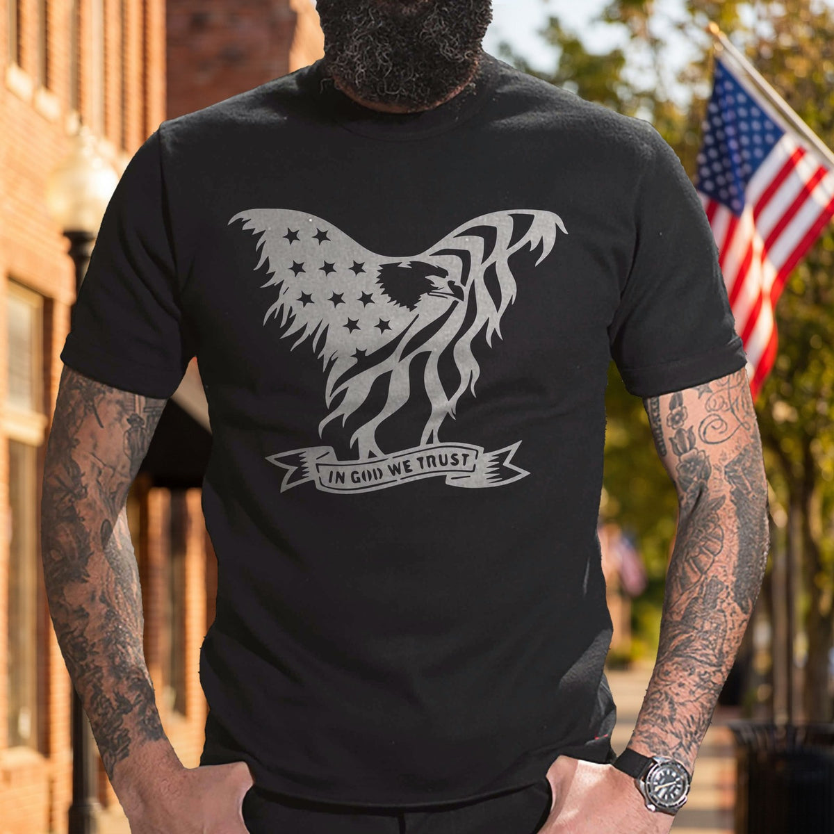 Eagle In God We Trust T-Shirt worn on a flag-lined main street