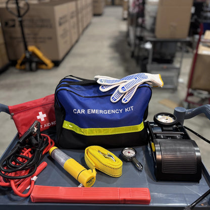 Emergency Car Kit packed with gloves on top, foot pump and tow strap on a shop cart