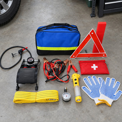 Emergency Car Kit contents laid out on a garage floor beside a car tire