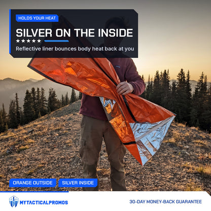 Man opening the Emergency Sleeping Bag to show the silver reflective liner at sunset