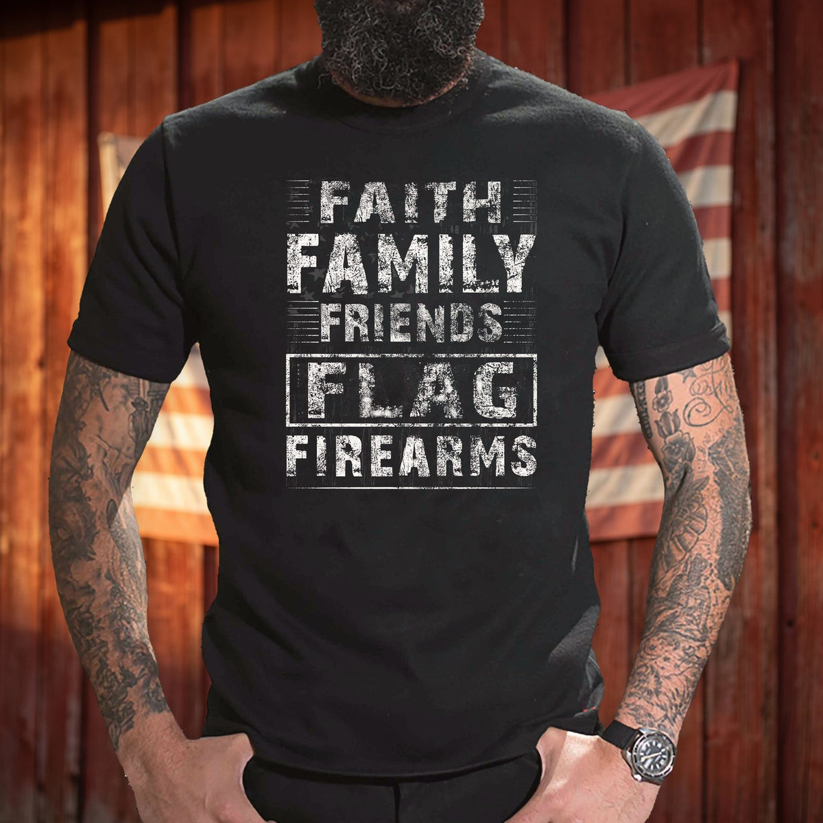 Faith Family Friends Flag Firearms T-Shirt worn in front of a red barn wall with an American flag