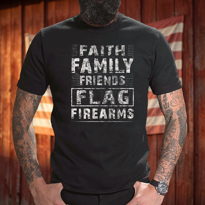 Faith Family Friends Flag Firearms T-Shirt worn in front of a red barn wall with an American flag
