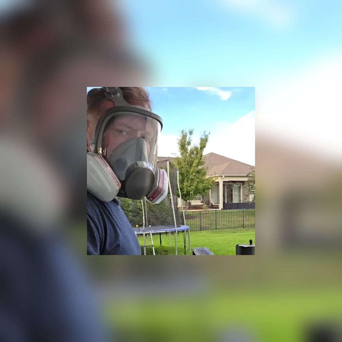 Man wearing the Full-Face Gas Mask outdoors in a backyard