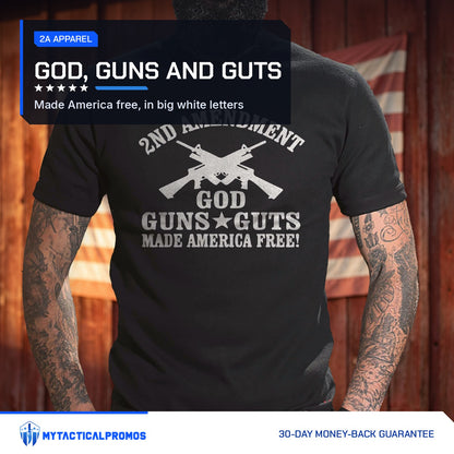 God, Guns and Guts T-Shirt worn by a man in front of a red barn wall with an American flag