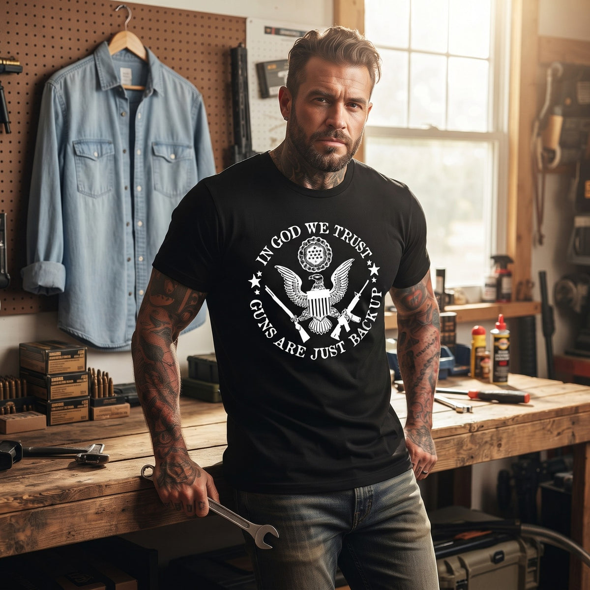 Guns Are Just Backup T-Shirt worn in a home workshop