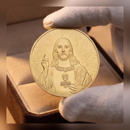 Jesus Commemorative Coin held in a white glove above a lined gift box