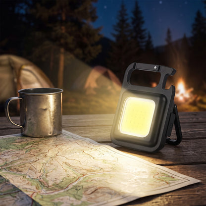 Keychain Light standing on its fold-out bracket over a map at camp
