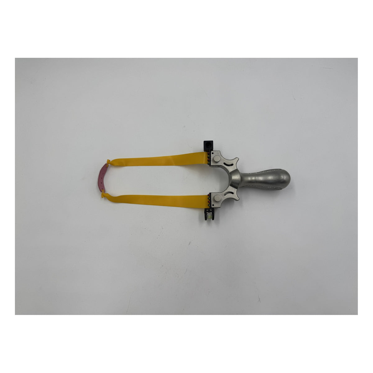 Laser Slingshot laid flat with its yellow flat band attached