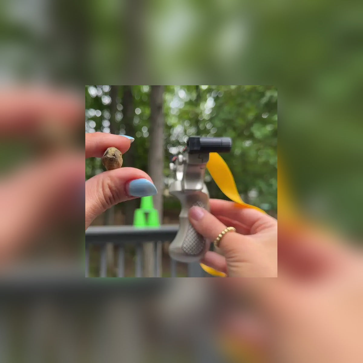 Aiming the Laser Slingshot at plastic cup targets in the backyard