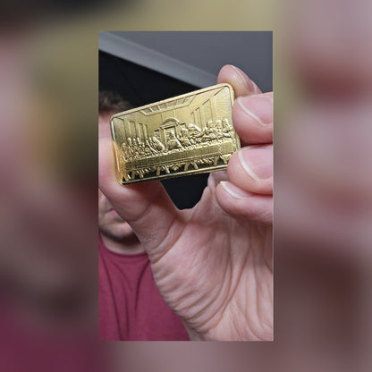 Last Supper gold-plated bar held between fingers for size
