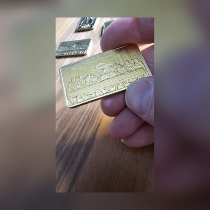 Last Supper gold-plated bar held over a wooden desk