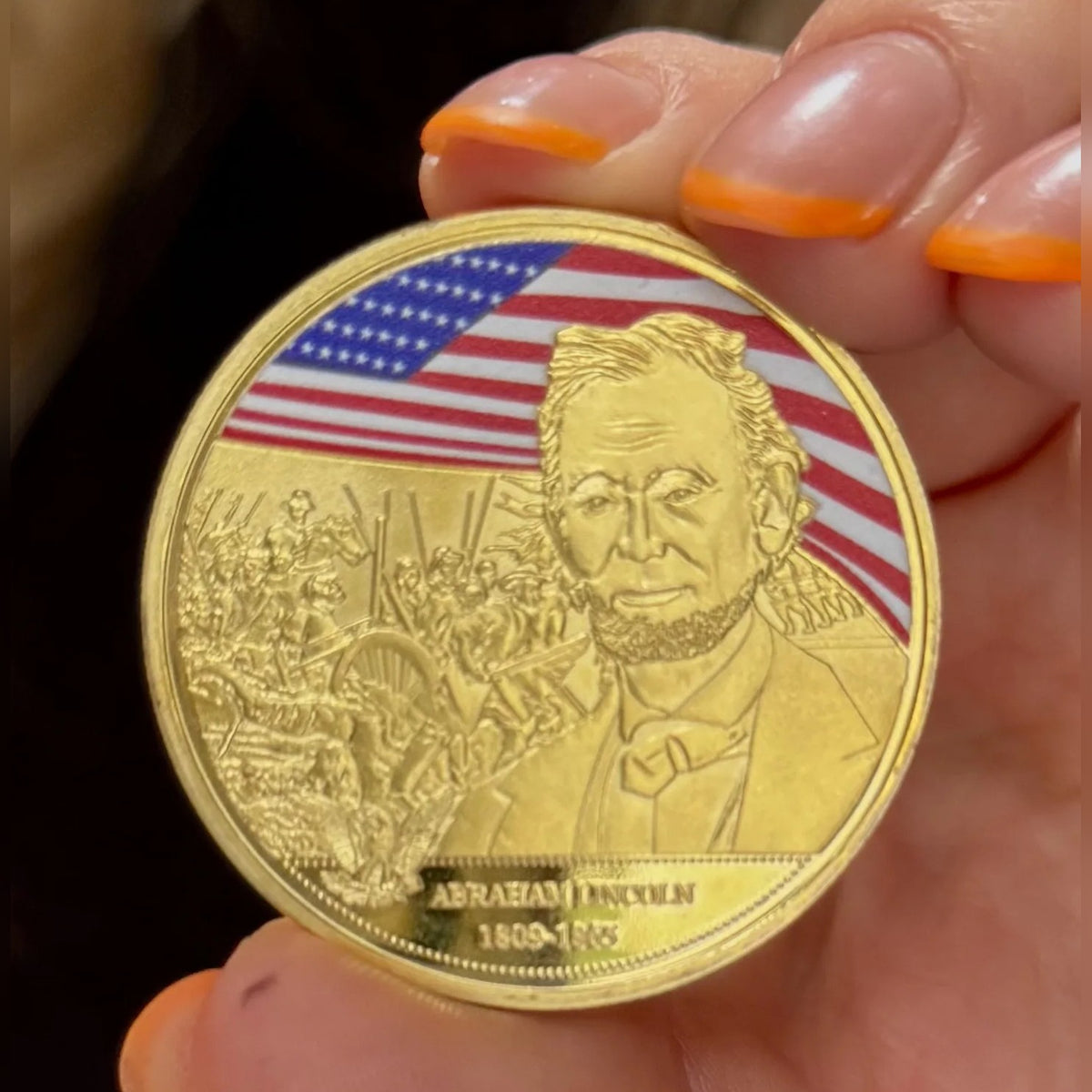 Abraham Lincoln Gold-Plated Coin front up close: color flag and Lincoln portrait