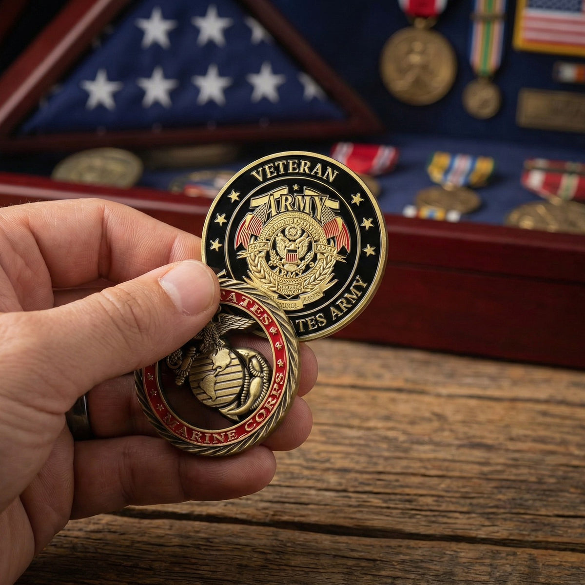 Marine Tribute Coin held in hand with the Army Veteran coin (sold separately) in front of a medal case
