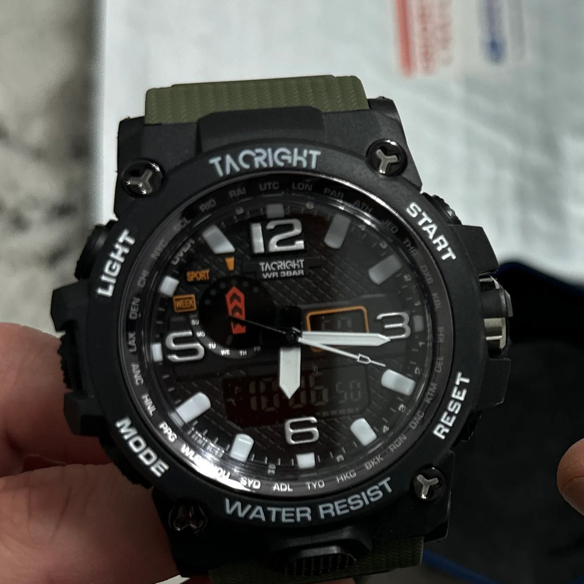 Military Watch front view held over a countertop