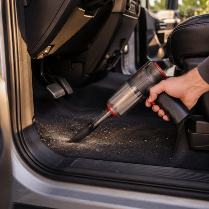 Mini Vacuum cleaning a car floor mat by the pedals
