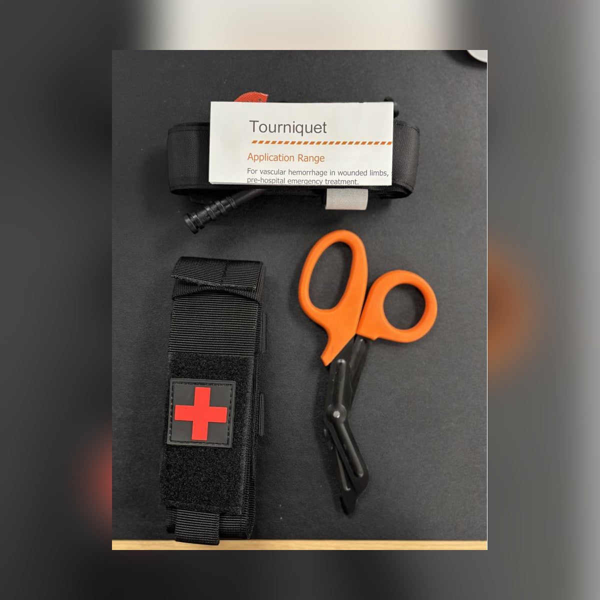 One-Arm Tourniquet Kit contents: tourniquet with instruction card, holster pouch and trauma shears