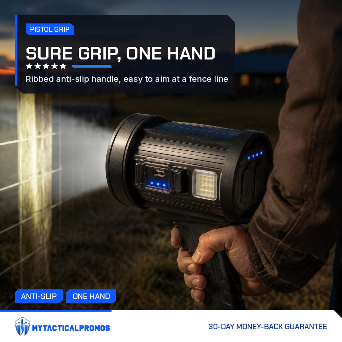 Hand holding the Outdoor Search Light by its pistol grip, lighting a farm fence at dusk