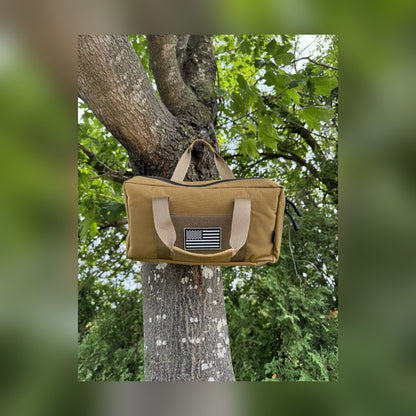 Pistol Gun Bag hanging by its handles from a tree branch