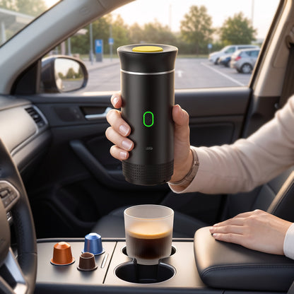 Portable Coffee Maker held in one hand inside a car