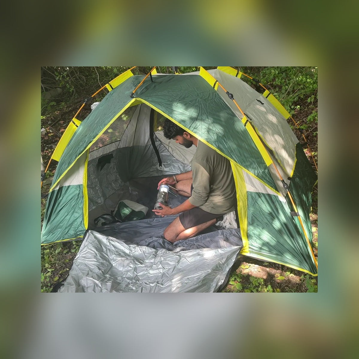 Man sitting inside the Quick Popup Tent with the door open