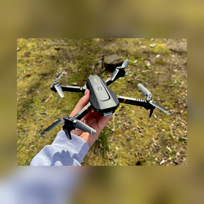 RC Drone held in one hand outdoors to show its size