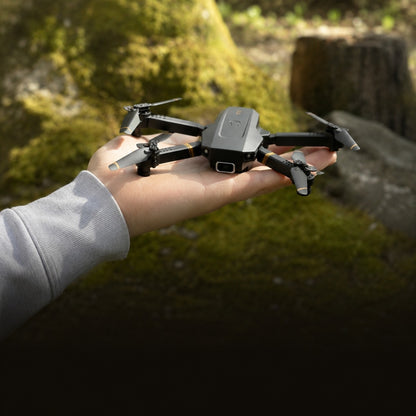 RC Drone resting in an open palm in the woods