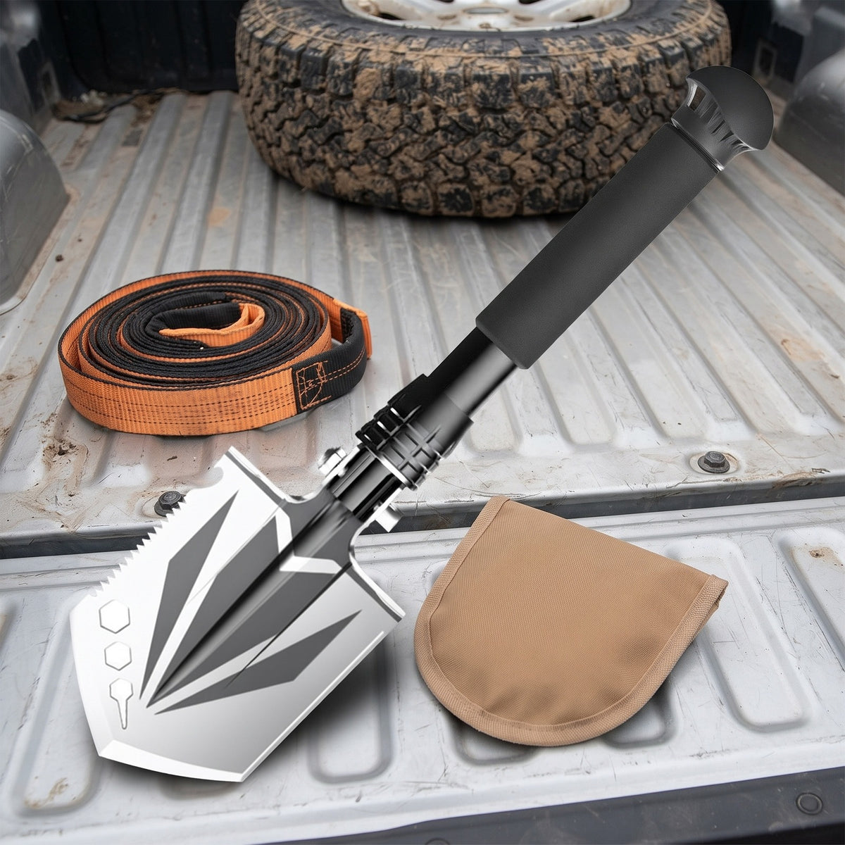 Compact Camp Shovel in a truck bed with a tow strap and its pouch