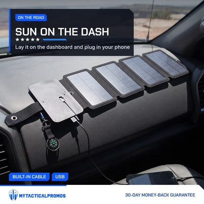 SolarFold solar charger unfolded on a truck dashboard charging a phone