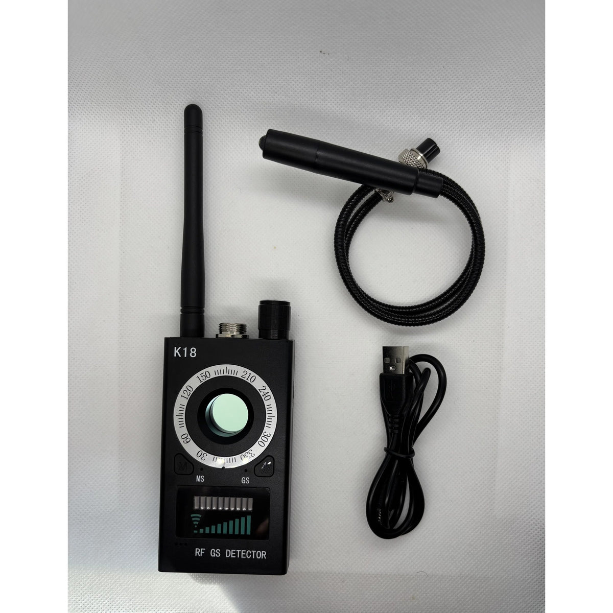 Spy Bug Detector with antenna, magnetic probe and USB charging cable laid out