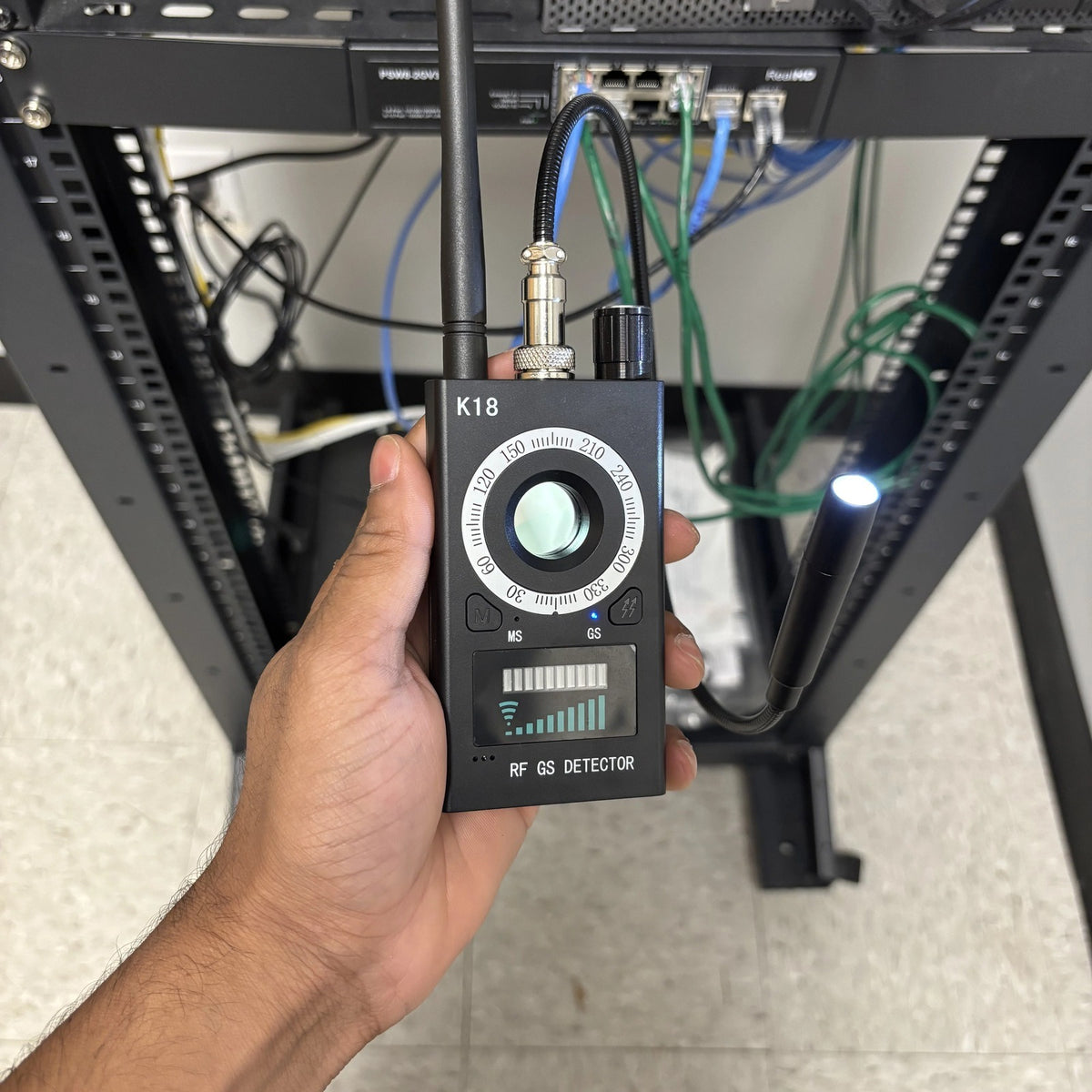 Spy Bug Detector checking a network equipment rack