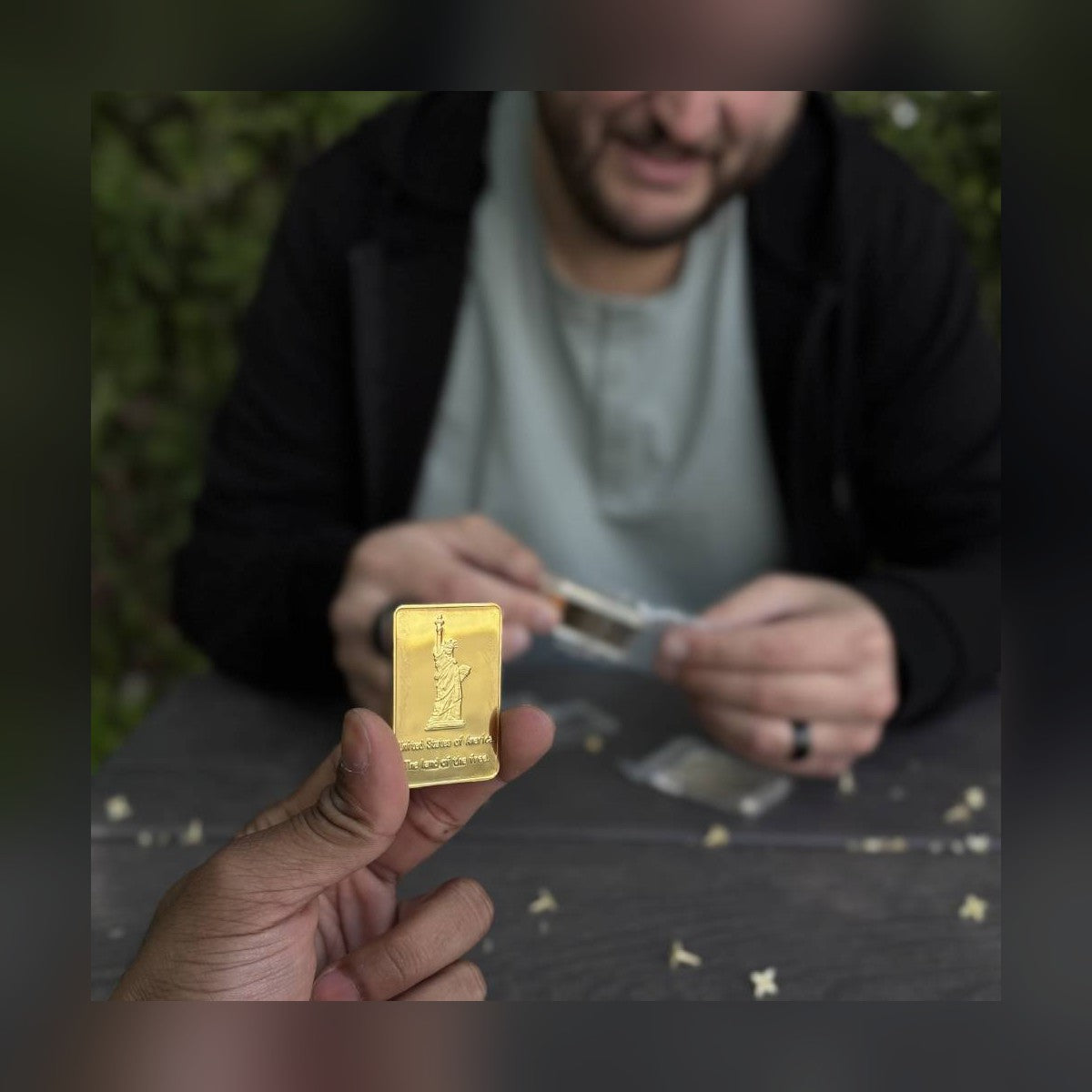 Man holding the Statue of Liberty gold-plated bar at a table