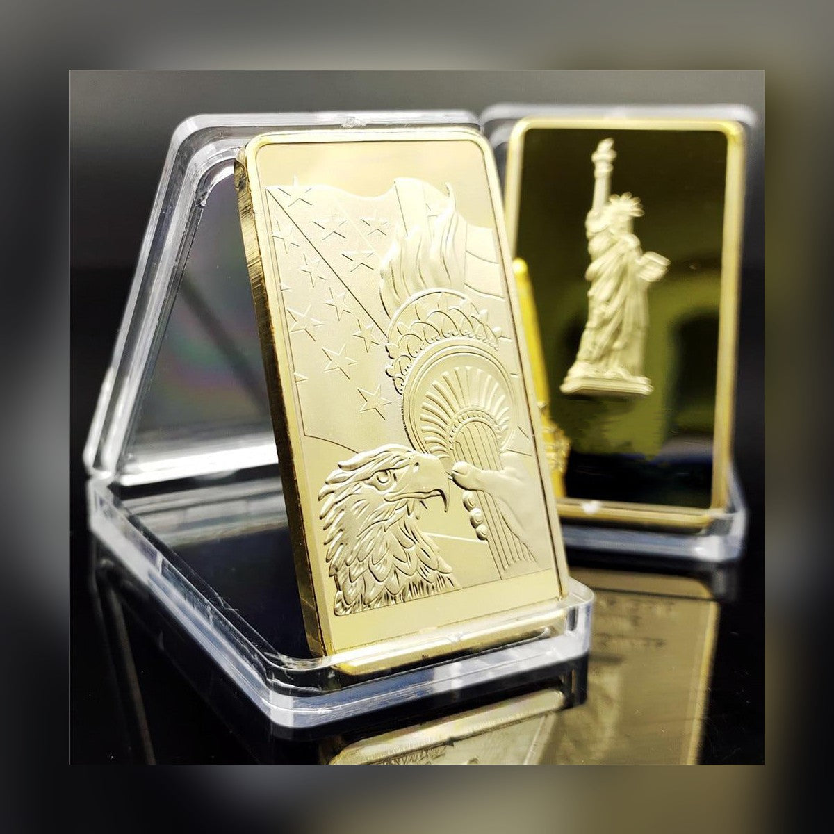 Statue of Liberty gold-plated bar in a clear stand with the reverse shown behind, studio shot