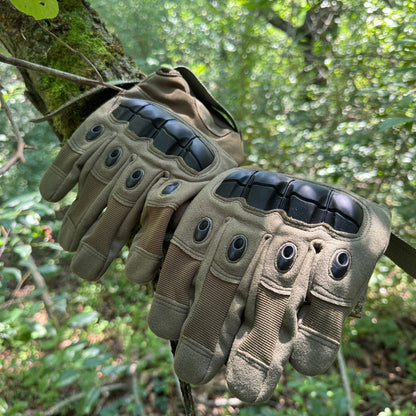Pair of Tactical Gloves resting on a mossy log in the forest