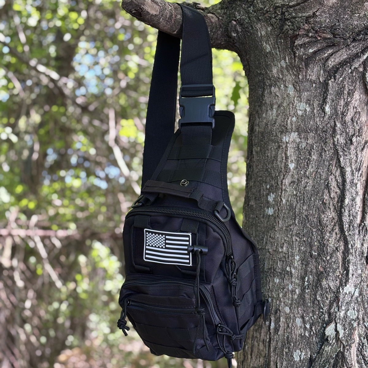 Tactical Shoulder Bag hanging from a tree by its shoulder strap