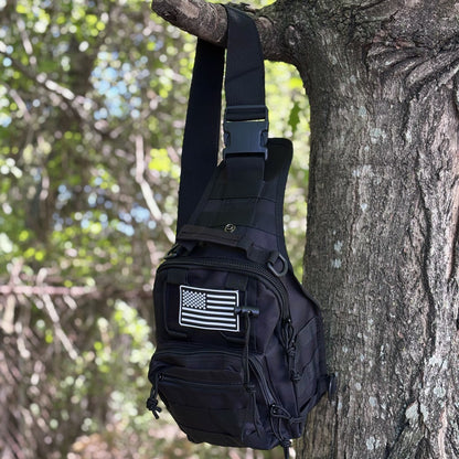 Tactical Shoulder Bag hanging from a tree by its shoulder strap