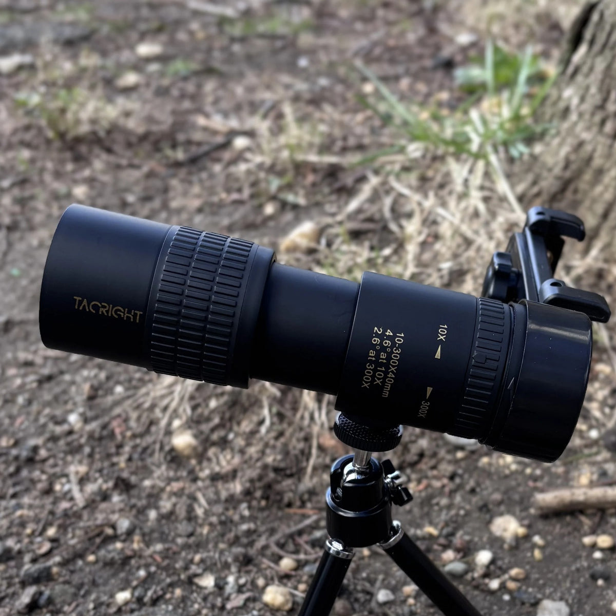 Zoom Monocular Telescope on its tripod with phone clip on a dirt trail