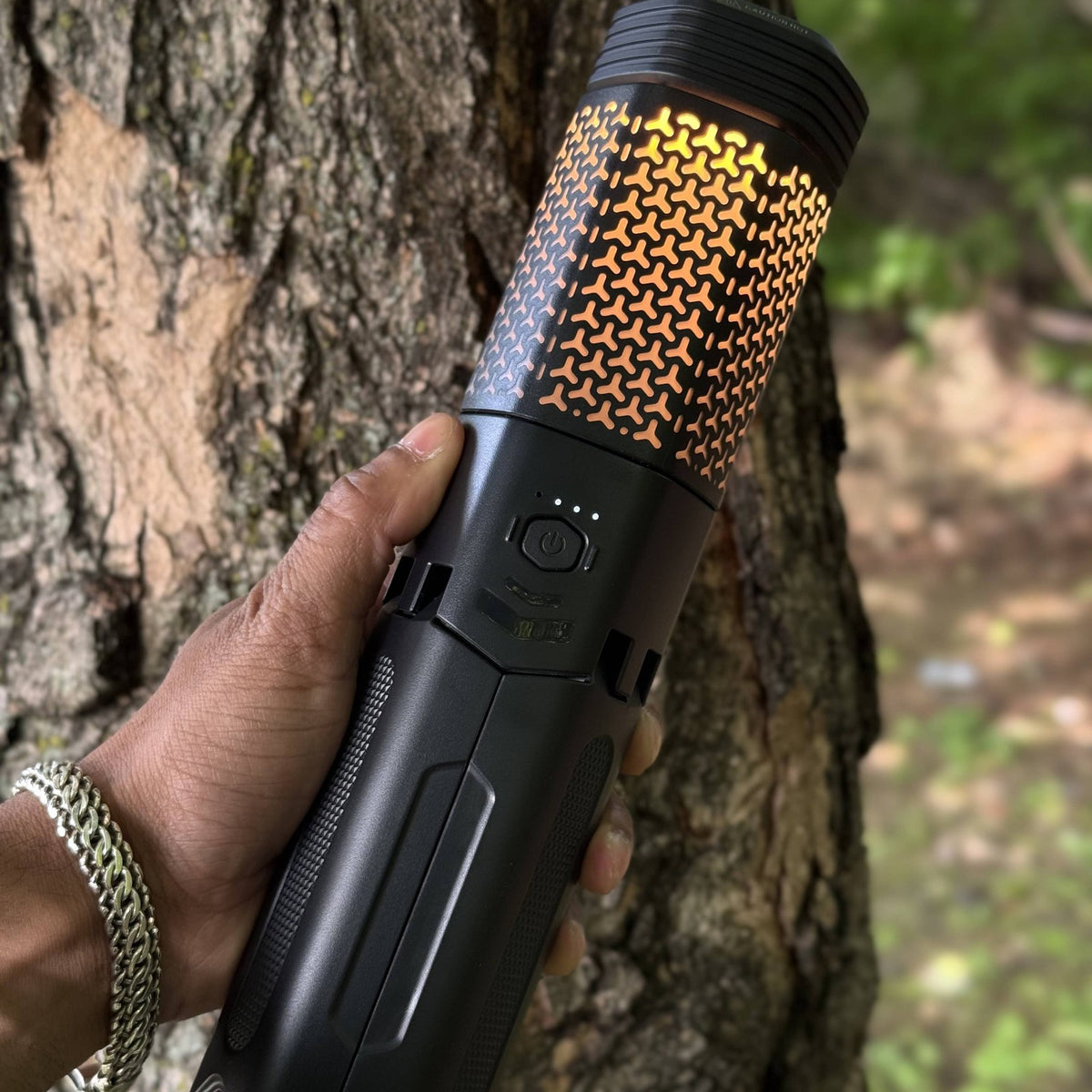 Telescoping Camping Lantern held in one hand with the lantern body glowing